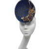 Blue and gold chevron detail percher with gold flower and quill detail.